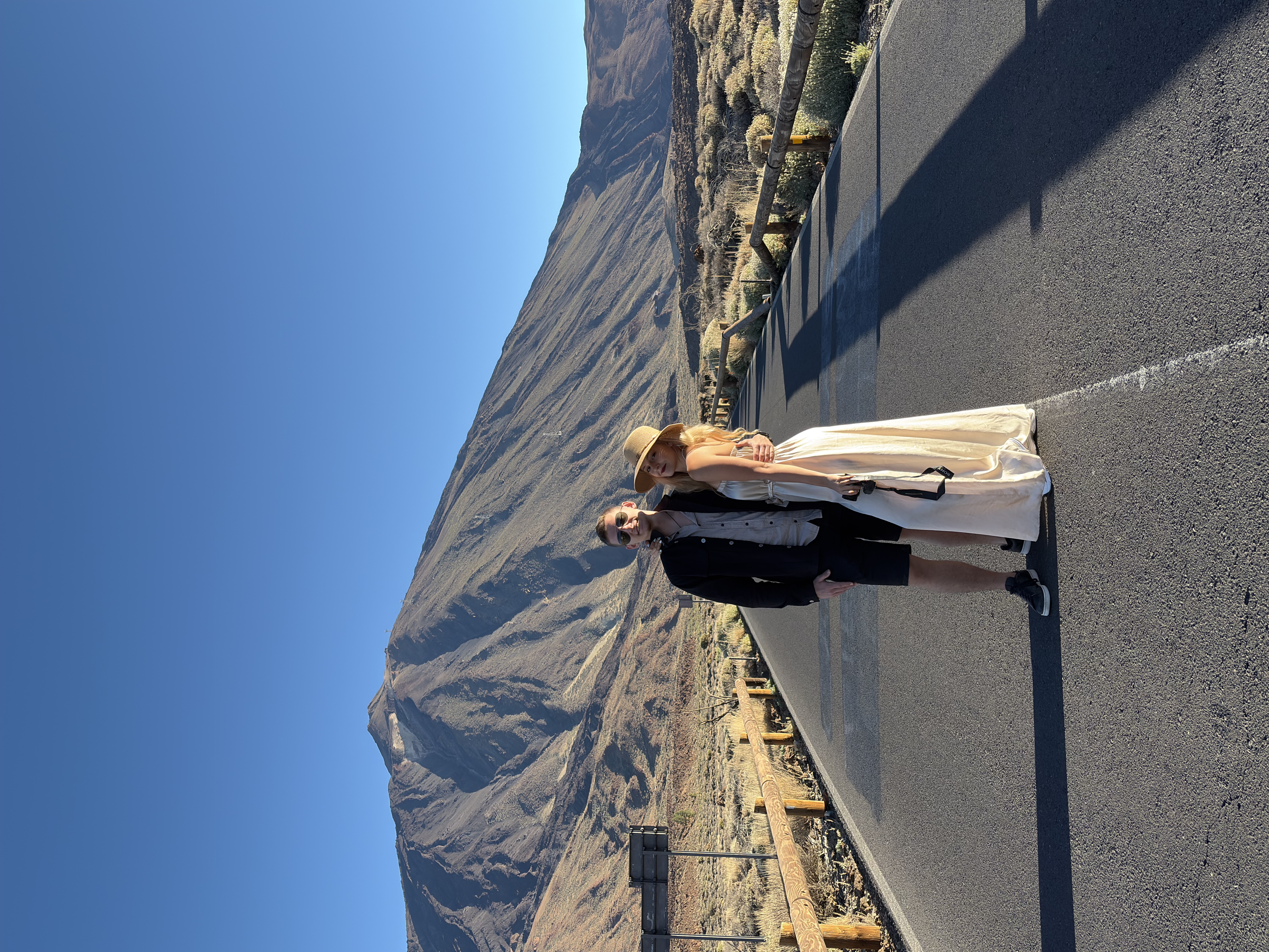 Christina and Martin on a road beneath a mountain